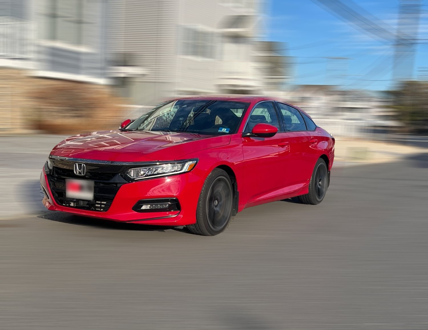 Bruno’s red Honda Accord on a shore-town street